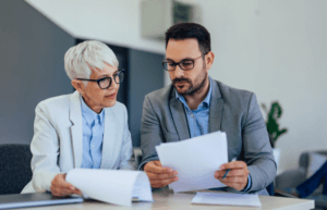 Mature woman and young man reviewing documents